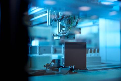 Close-up of a robotic arm tasting biology tests